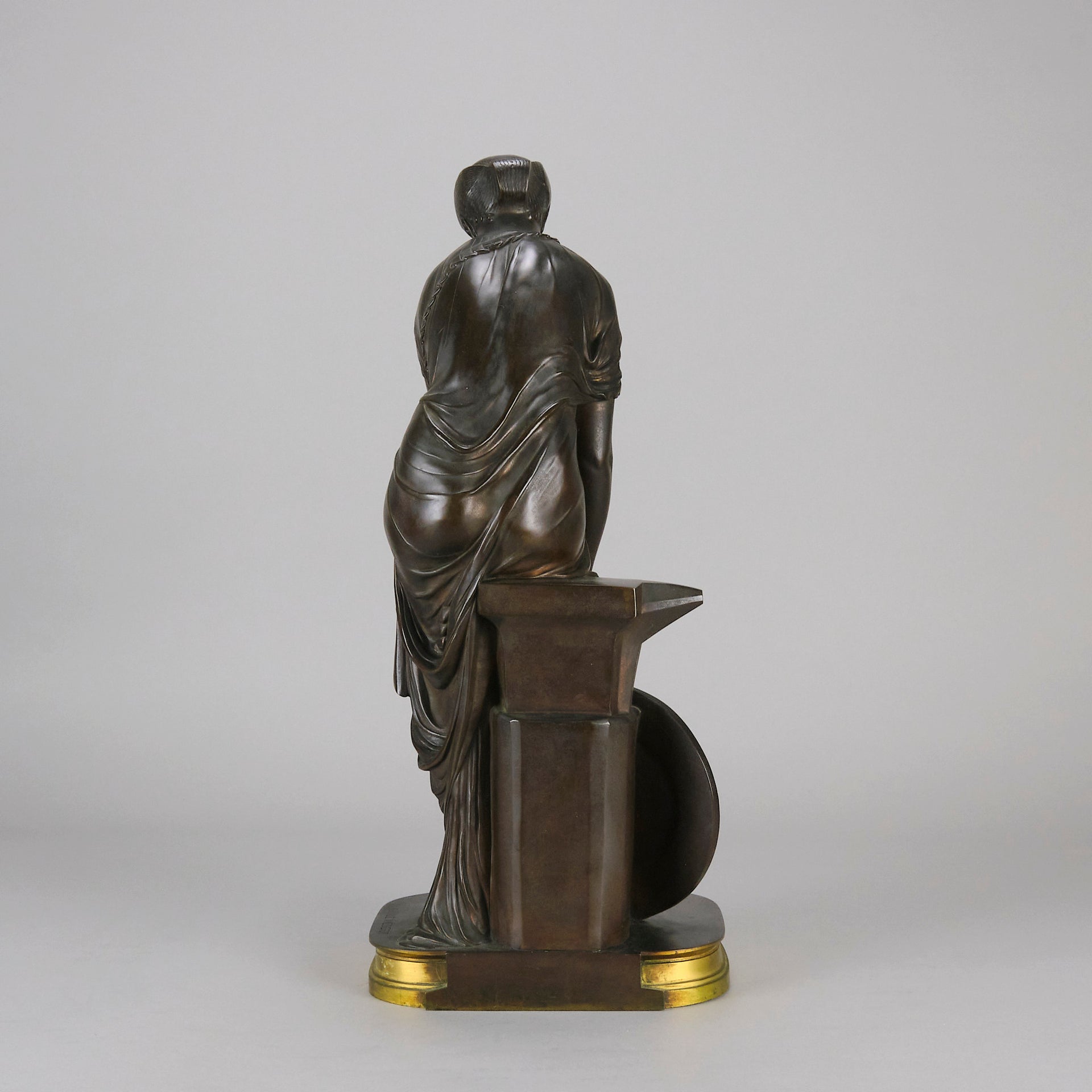 Thetis by Emile Hébert - a French late 19th Century bronze, of a striking female warrior figure known as Thetis the Greek Goddess of War. She is adjusting her shin guards in preparation for her next opponent, whilst sitting on an anvil. Raised on top of a partly gilded base
