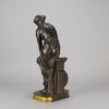 Thetis by Emile Hébert - a French late 19th Century bronze, of a striking female warrior figure known as Thetis the Greek Goddess of War. She is adjusting her shin guards in preparation for her next opponent, whilst sitting on an anvil. Raised on top of a partly gilded base