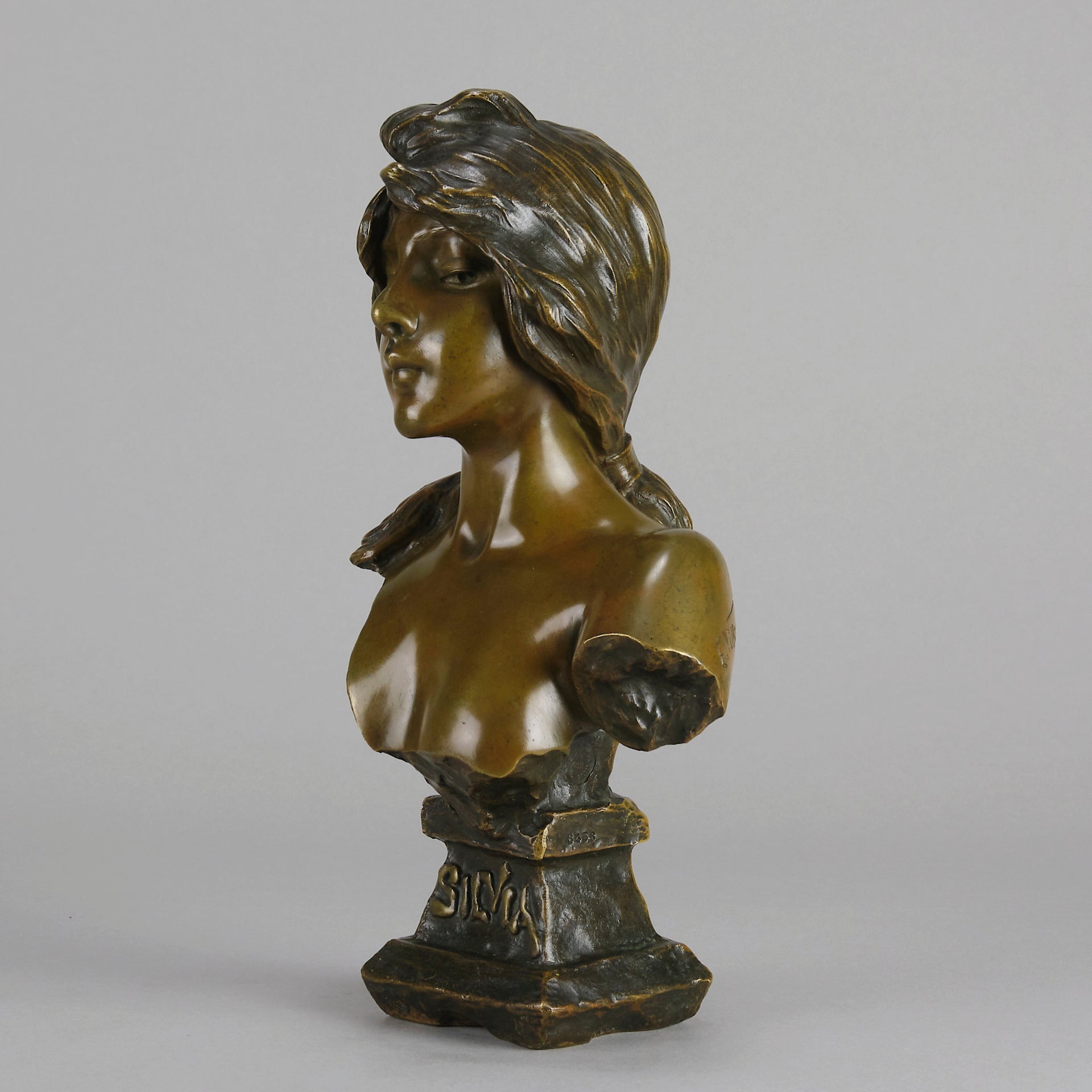 Silvia by Emmanuel Villanis a very fine late 19th Century French bronze bust of an attractive classical maiden modelled in the Art Nouveau style, with fabulous multi hued patination of brown and a subtle green