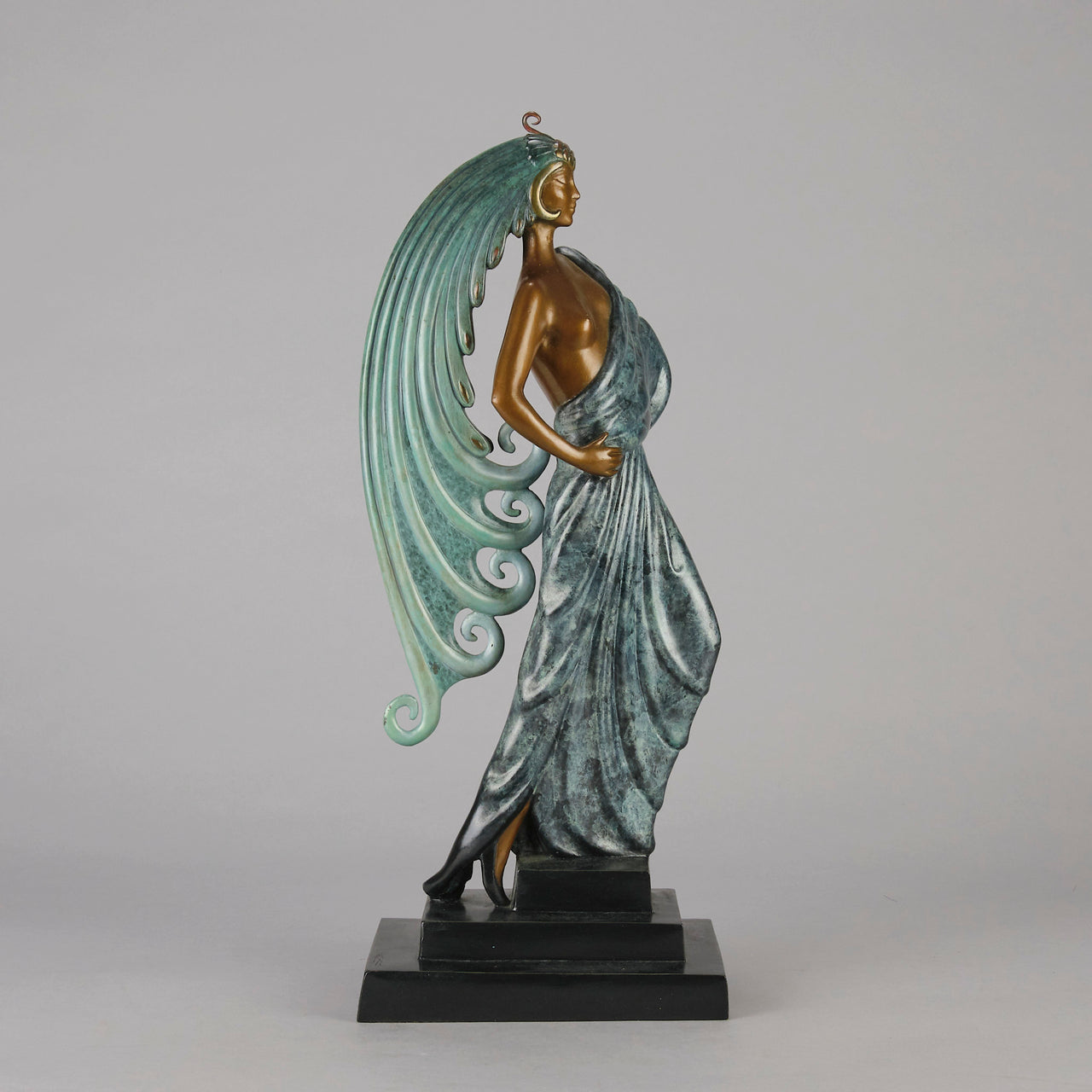  Beauty and the Beast by Erté a limited edition 20th Century bronze figure modelled as a beautiful young woman walking up a set of stairs wearing an impressive headdress and draped in a panther fur 