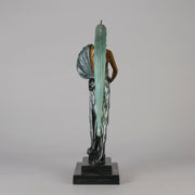  Beauty and the Beast by Erté a limited edition 20th Century bronze figure modelled as a beautiful young woman walking up a set of stairs wearing an impressive headdress and draped in a panther fur 