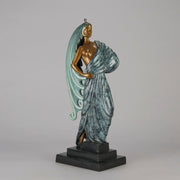  Beauty and the Beast by Erté a limited edition 20th Century bronze figure modelled as a beautiful young woman walking up a set of stairs wearing an impressive headdress and draped in a panther fur 