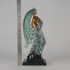  Beauty and the Beast by Erté a limited edition 20th Century bronze figure modelled as a beautiful young woman walking up a set of stairs wearing an impressive headdress and draped in a panther fur 