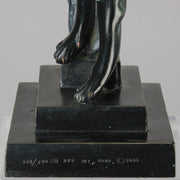  Beauty and the Beast by Erté a limited edition 20th Century bronze figure modelled as a beautiful young woman walking up a set of stairs wearing an impressive headdress and draped in a panther fur 