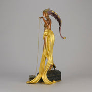 Pleasures of the Courtesan by Erté an attractive limited edition 20th Century bronze figure modelled as a beautiful young woman holding a long golden chain from a treasure chest at her feet wearing only an flamboyant skirt & headdress