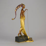 Pleasures of the Courtesan by Erté an attractive limited edition 20th Century bronze figure modelled as a beautiful young woman holding a long golden chain from a treasure chest at her feet wearing only an flamboyant skirt & headdress
