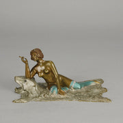 Lady on Bear Skin by Toni Fiedler an attractive early 20th Century bronze study of a lady wearing only a pair of stockings and heals seductively laying on a bear skin rug whilst smoking a cigarette