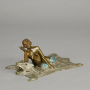 Lady on Bear Skin by Toni Fiedler an attractive early 20th Century bronze study of a lady wearing only a pair of stockings and heals seductively laying on a bear skin rug whilst smoking a cigarette