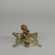 Lady on Bear Skin by Toni Fiedler an attractive early 20th Century bronze study of a lady wearing only a pair of stockings and heals seductively laying on a bear skin rug whilst smoking a cigarette