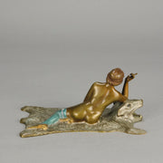 Lady on Bear Skin by Toni Fiedler an attractive early 20th Century bronze study of a lady wearing only a pair of stockings and heals seductively laying on a bear skin rug whilst smoking a cigarette