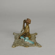 Lady on Bear Skin by Toni Fiedler an attractive early 20th Century bronze study of a lady wearing only a pair of stockings and heals seductively laying on a bear skin rug whilst smoking a cigarette