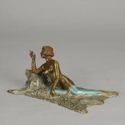 Lady on Bear Skin by Toni Fiedler an attractive early 20th Century bronze study of a lady wearing only a pair of stockings and heals seductively laying on a bear skin rug whilst smoking a cigarette