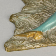 Lady on Bear Skin by Toni Fiedler an attractive early 20th Century bronze study of a lady wearing only a pair of stockings and heals seductively laying on a bear skin rug whilst smoking a cigarette