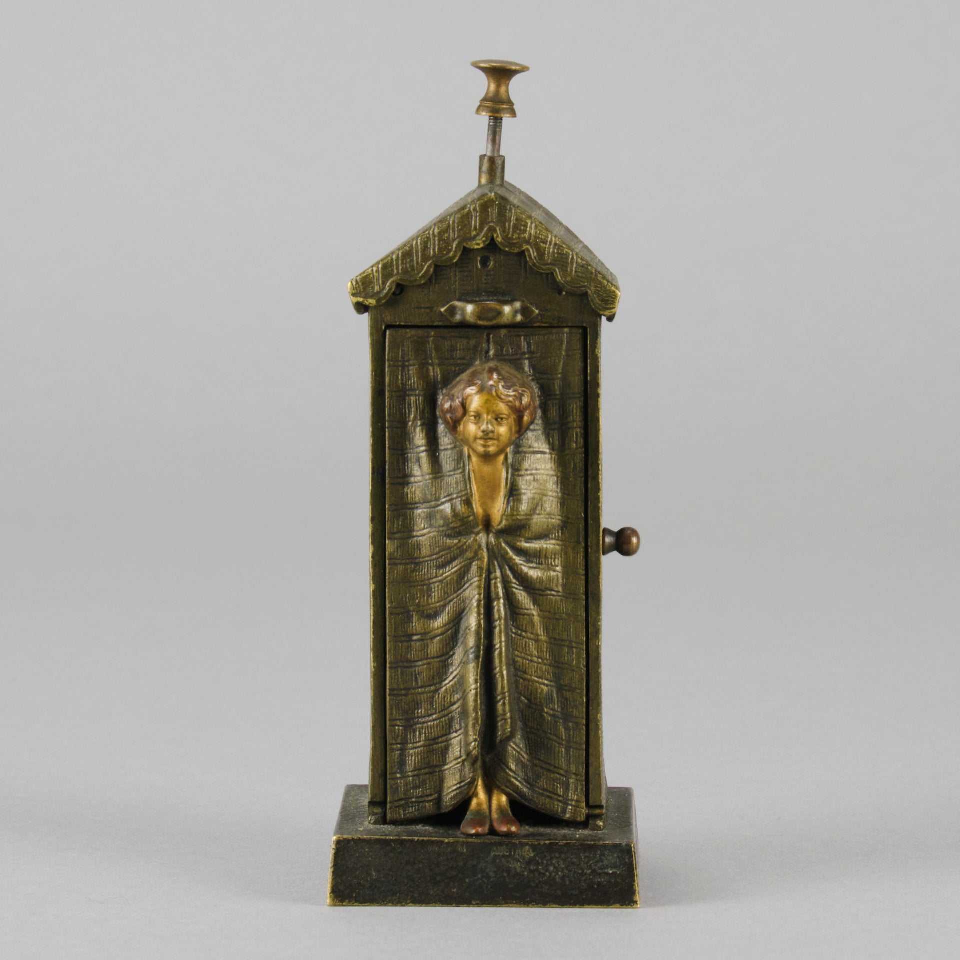 Bathing Belle by Franz Bergman an amusingly erotic early 20th Century Austrian bronze figure of a young beauty in a seaside hut peeking out between the curtains. The mechanism pushes down to turn the front curtain around revealing 'what the butler saw' as her naked body is revealed from behind