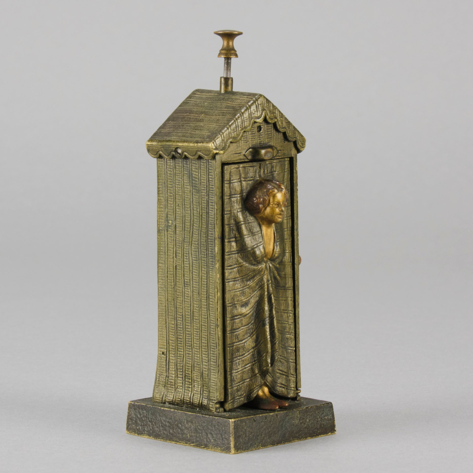 Bathing Belle by Franz Bergman an amusingly erotic early 20th Century Austrian bronze figure of a young beauty in a seaside hut peeking out between the curtains. The mechanism pushes down to turn the front curtain around revealing 'what the butler saw' as her naked body is revealed from behind