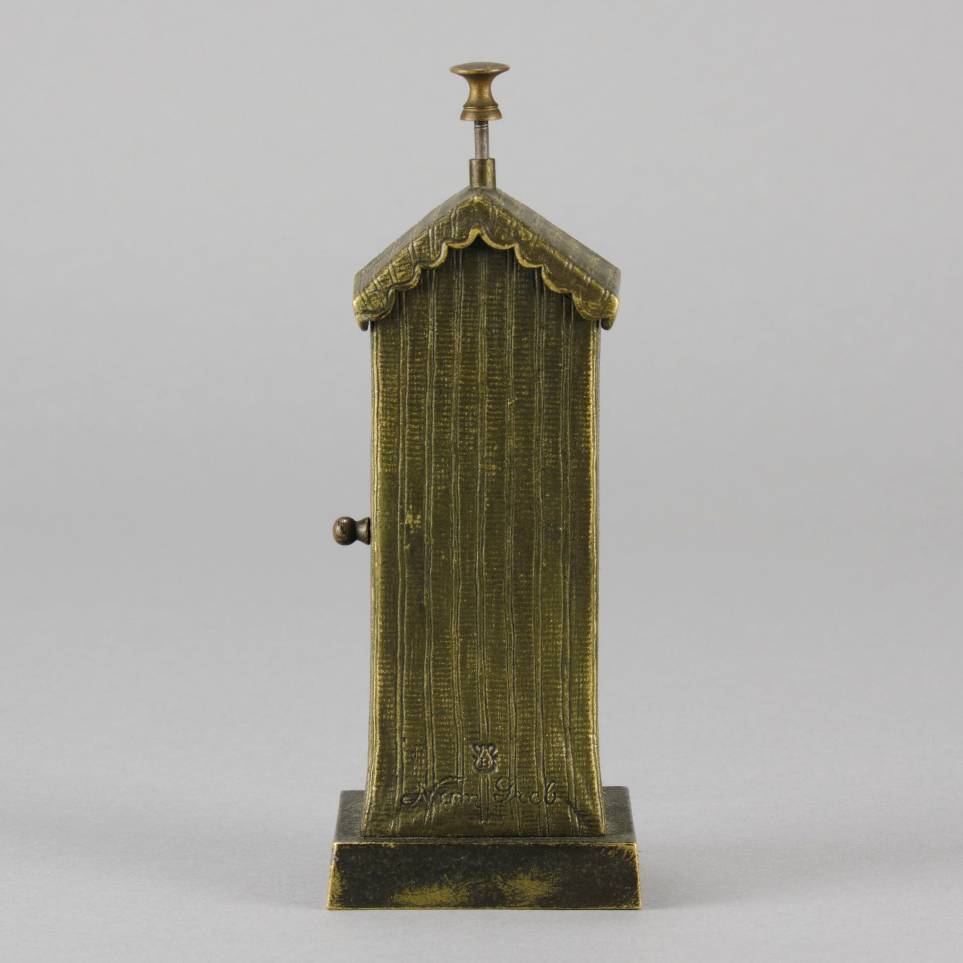 Bathing Belle by Franz Bergman an amusingly erotic early 20th Century Austrian bronze figure of a young beauty in a seaside hut peeking out between the curtains. The mechanism pushes down to turn the front curtain around revealing 'what the butler saw' as her naked body is revealed from behind