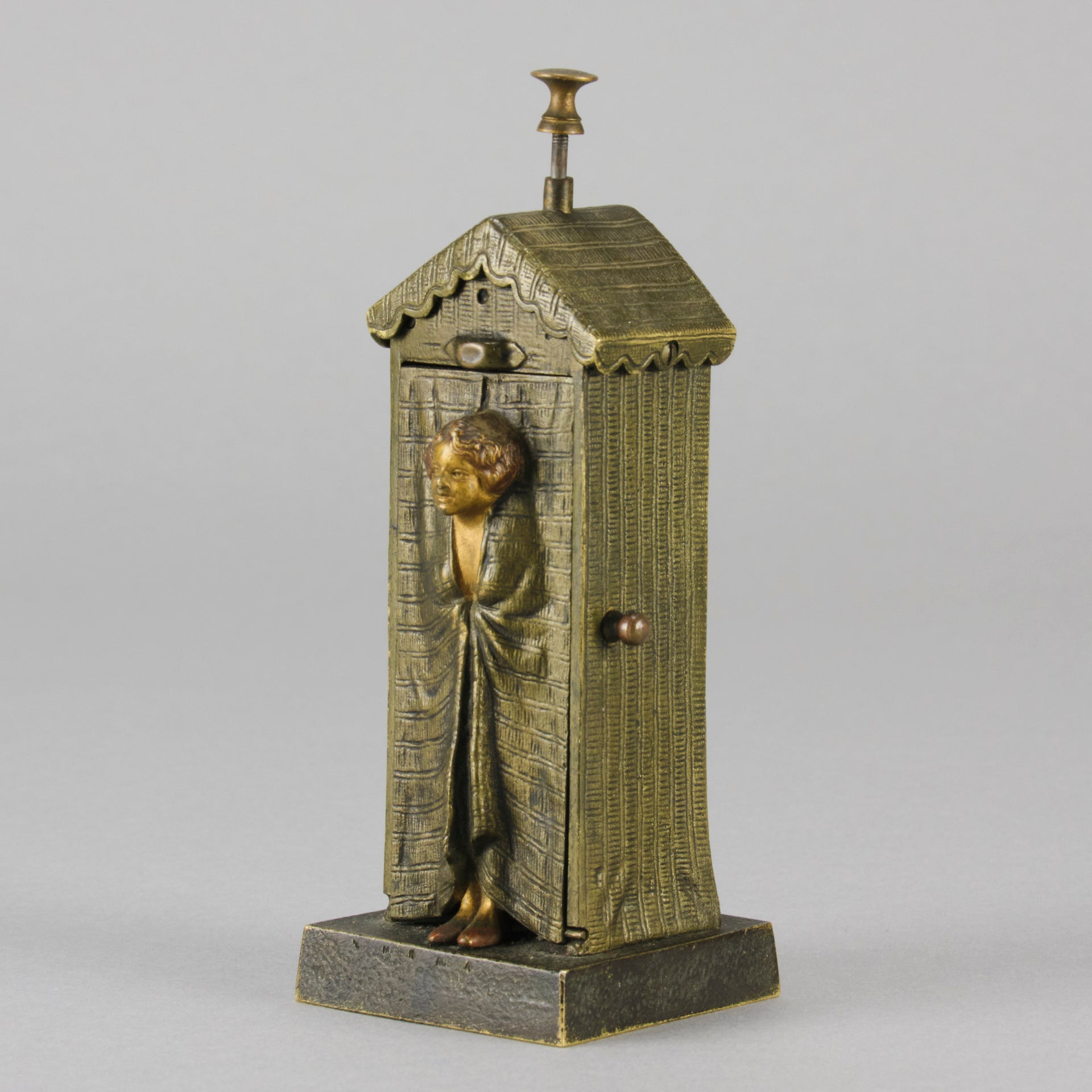 Bathing Belle by Franz Bergman an amusingly erotic early 20th Century Austrian bronze figure of a young beauty in a seaside hut peeking out between the curtains. The mechanism pushes down to turn the front curtain around revealing 'what the butler saw' as her naked body is revealed from behind