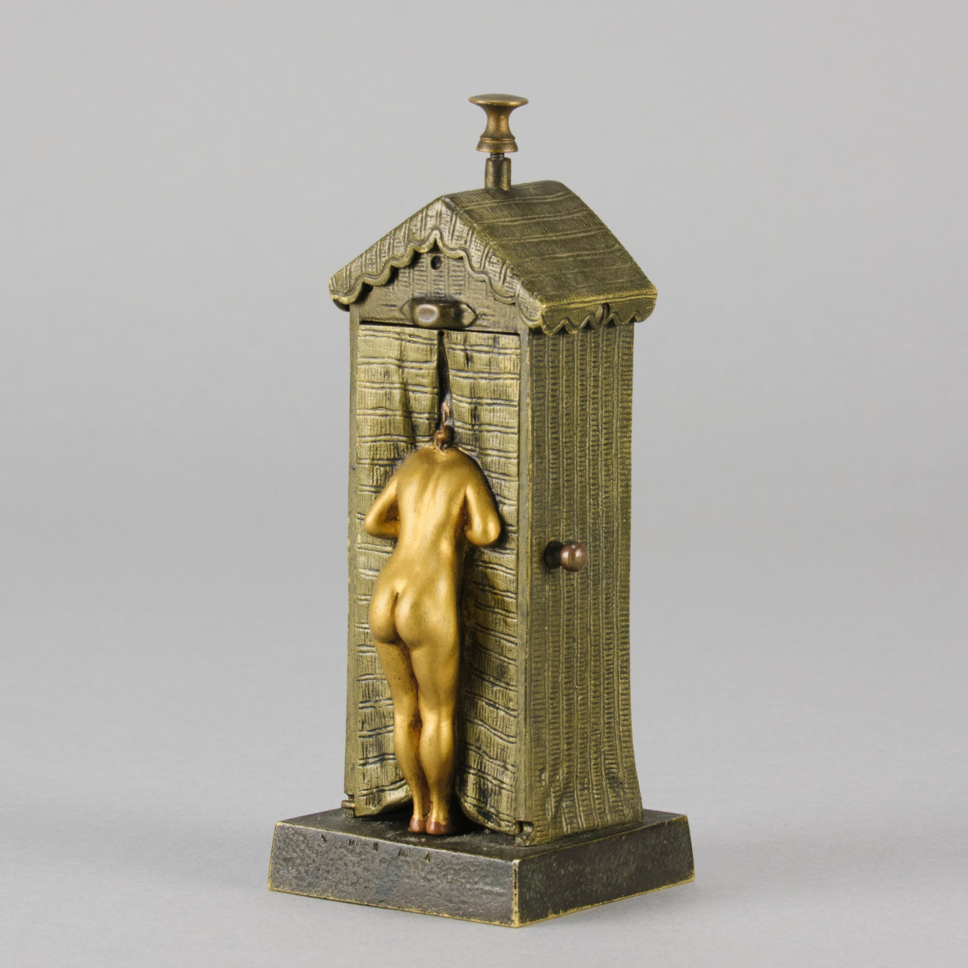 Bathing Belle by Franz Bergman an amusingly erotic early 20th Century Austrian bronze figure of a young beauty in a seaside hut peeking out between the curtains. The mechanism pushes down to turn the front curtain around revealing 'what the butler saw' as her naked body is revealed from behind