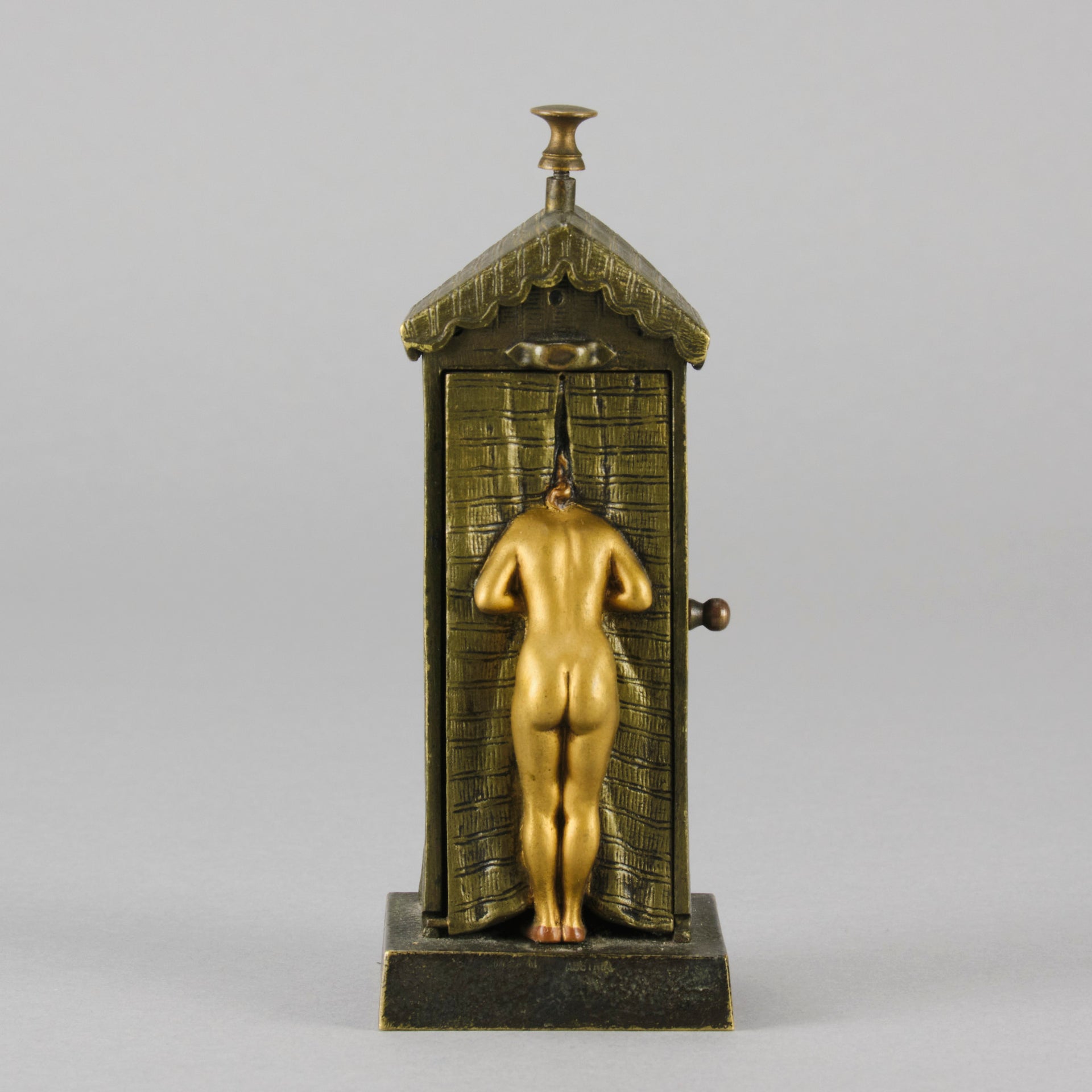Bathing Belle by Franz Bergman an amusingly erotic early 20th Century Austrian bronze figure of a young beauty in a seaside hut peeking out between the curtains. The mechanism pushes down to turn the front curtain around revealing 'what the butler saw' as her naked body is revealed from behind