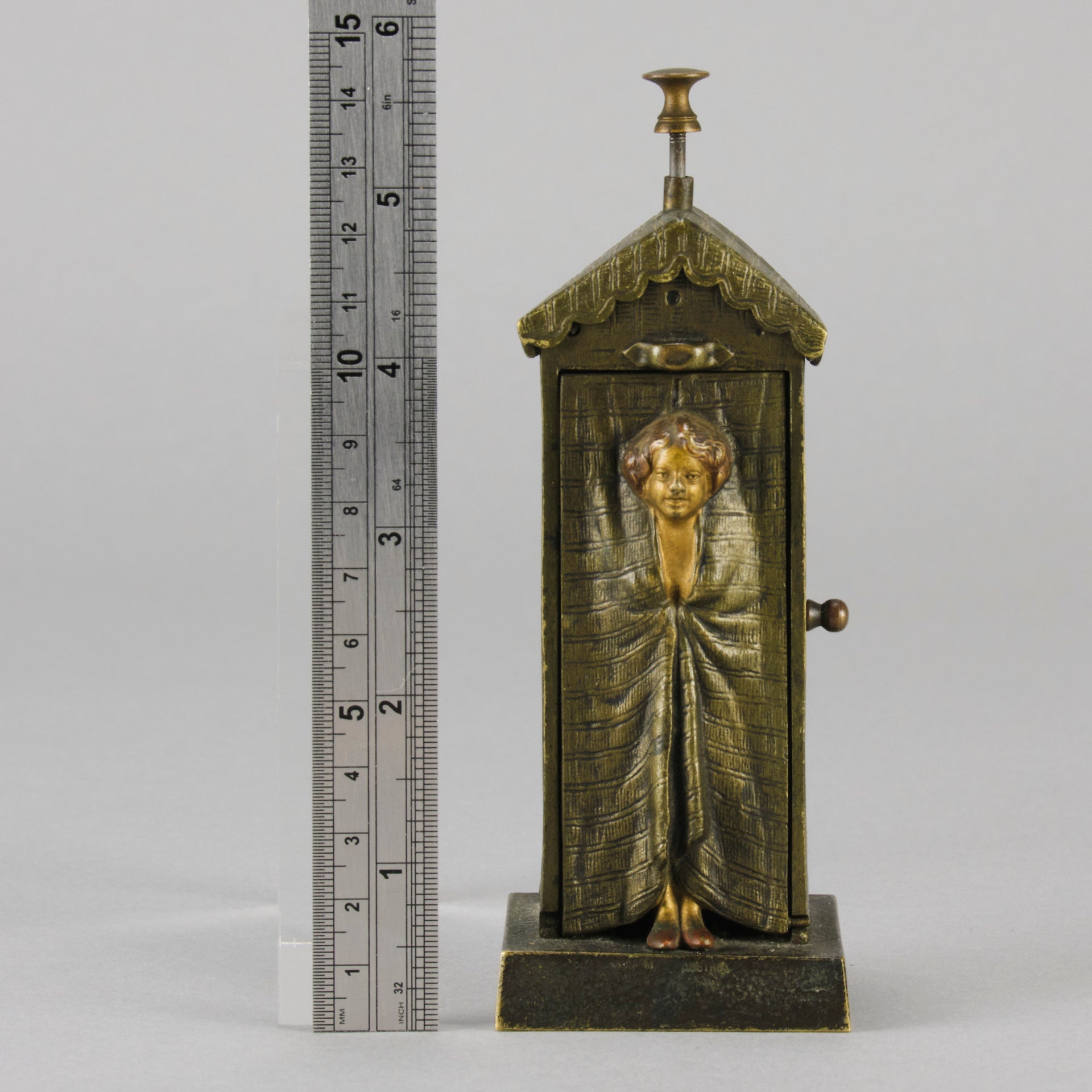 Bathing Belle by Franz Bergman an amusingly erotic early 20th Century Austrian bronze figure of a young beauty in a seaside hut peeking out between the curtains. The mechanism pushes down to turn the front curtain around revealing 'what the butler saw' as her naked body is revealed from behind