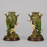 A Pair of Bird Vases by Franz Bergman decorated with Ibis standing amongst bulrush raised on a naturalistic bases with very fine colours and good hand finished surface detail 