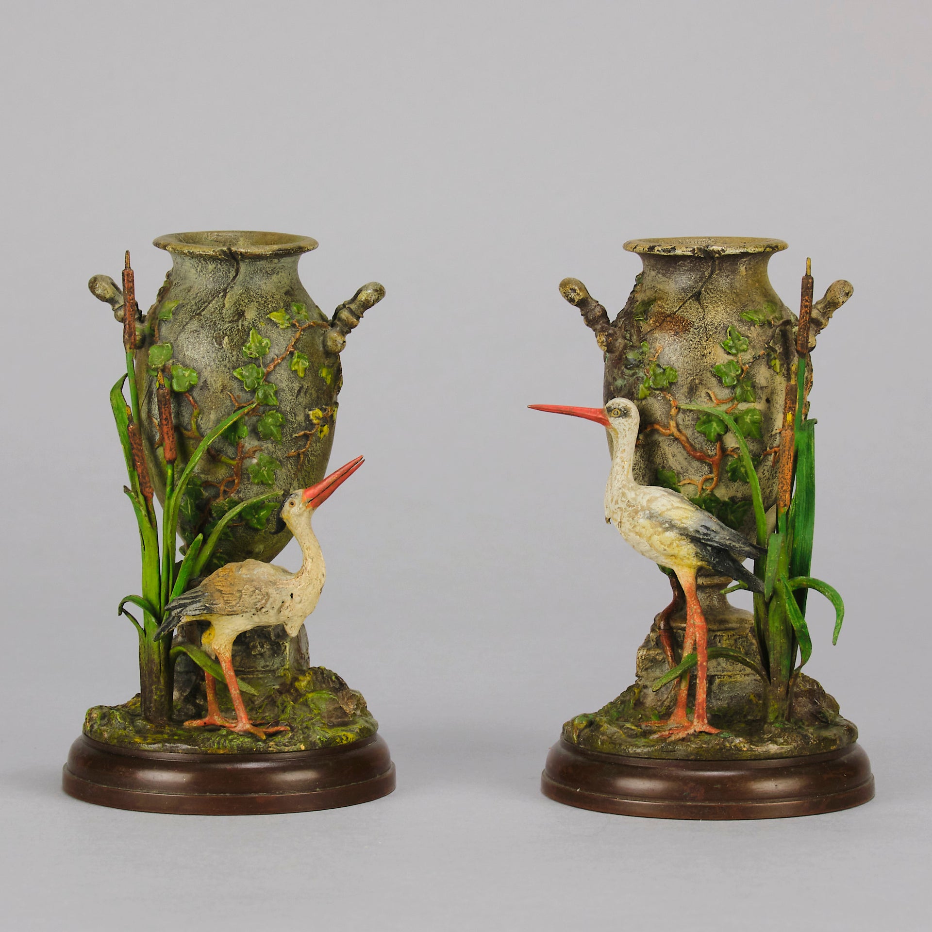 A Pair of Bird Vases by Franz Bergman decorated with Ibis standing amongst bulrush raised on a naturalistic bases with very fine colours and good hand finished surface detail 