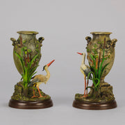 A Pair of Bird Vases by Franz Bergman decorated with Ibis standing amongst bulrush raised on a naturalistic bases with very fine colours and good hand finished surface detail 