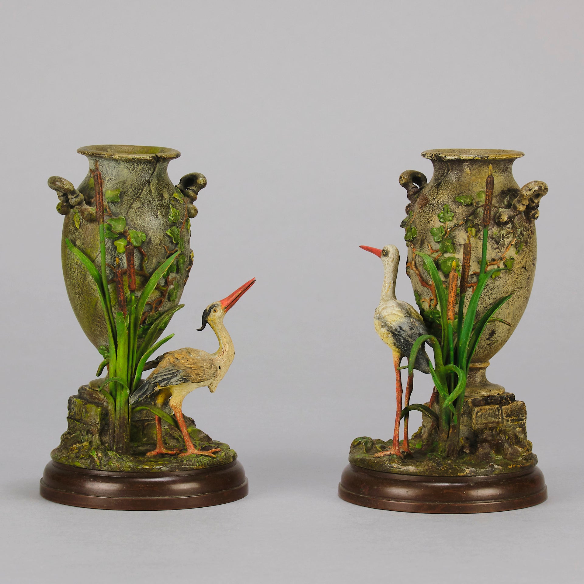 A Pair of Bird Vases by Franz Bergman decorated with Ibis standing amongst bulrush raised on a naturalistic bases with very fine colours and good hand finished surface detail 