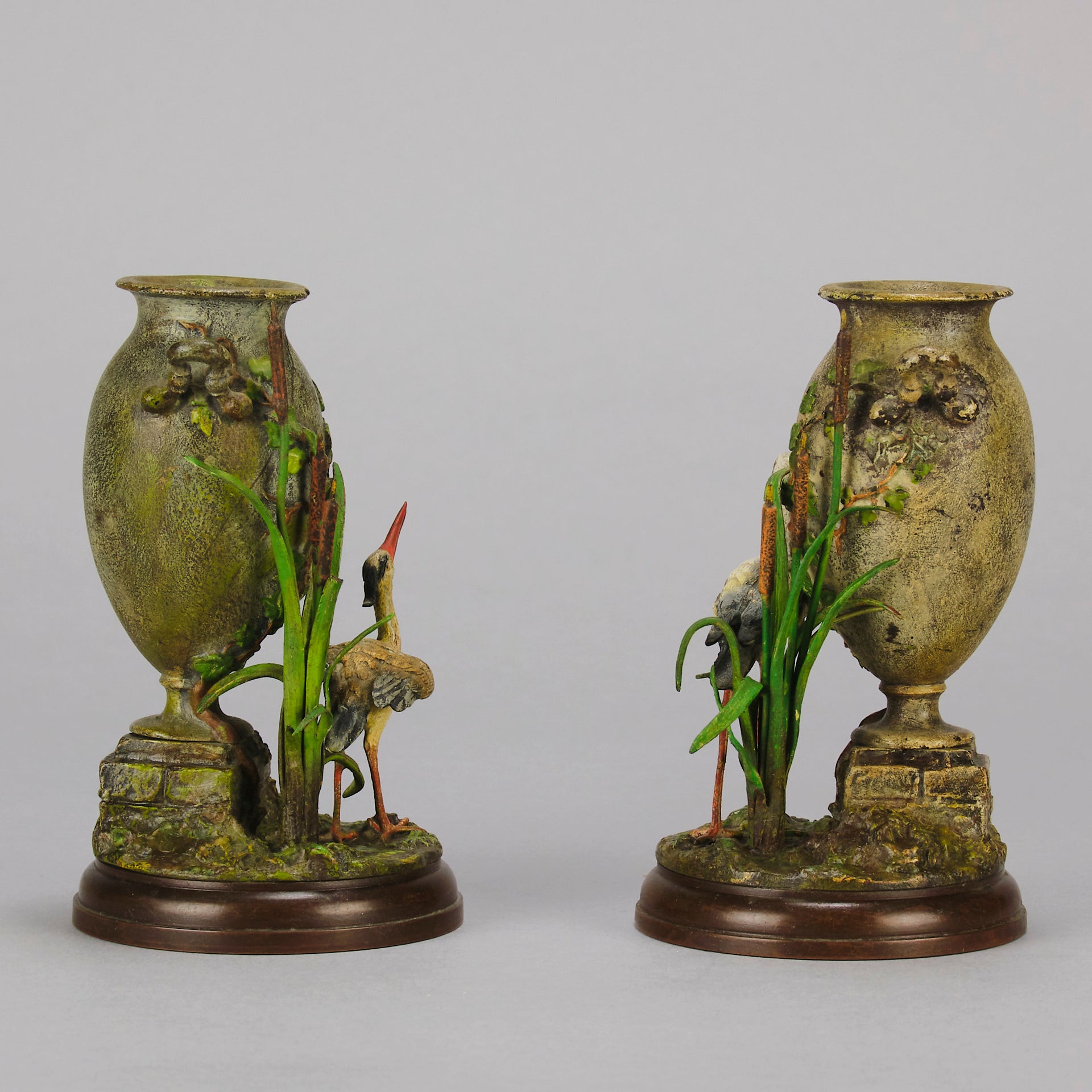 A Pair of Bird Vases by Franz Bergman decorated with Ibis standing amongst bulrush raised on a naturalistic bases with very fine colours and good hand finished surface detail 