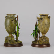 A Pair of Bird Vases by Franz Bergman decorated with Ibis standing amongst bulrush raised on a naturalistic bases with very fine colours and good hand finished surface detail 
