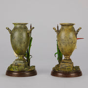 A Pair of Bird Vases by Franz Bergman decorated with Ibis standing amongst bulrush raised on a naturalistic bases with very fine colours and good hand finished surface detail 