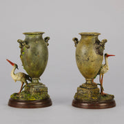 A Pair of Bird Vases by Franz Bergman decorated with Ibis standing amongst bulrush raised on a naturalistic bases with very fine colours and good hand finished surface detail 