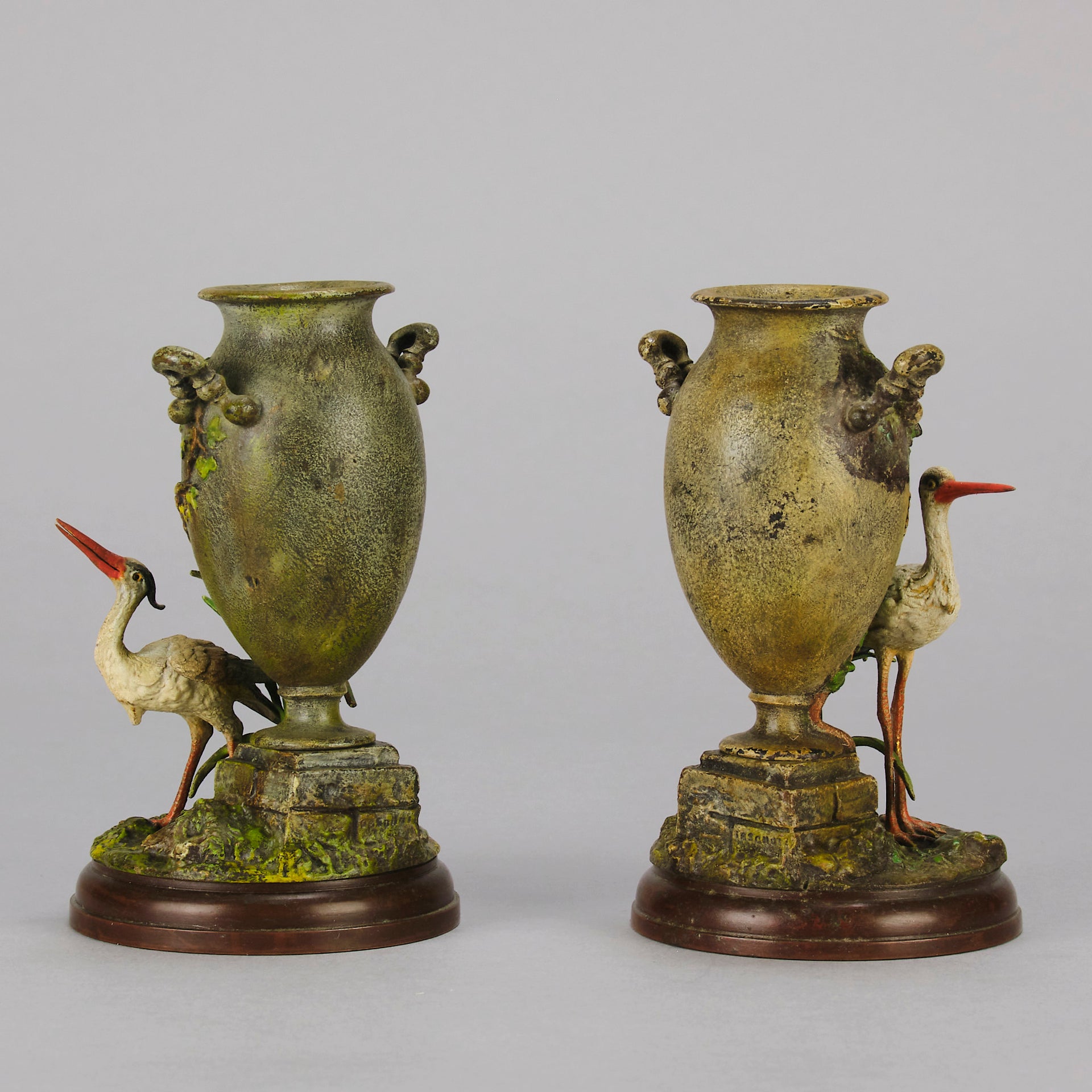 A Pair of Bird Vases by Franz Bergman decorated with Ibis standing amongst bulrush raised on a naturalistic bases with very fine colours and good hand finished surface detail 