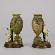 A Pair of Bird Vases by Franz Bergman decorated with Ibis standing amongst bulrush raised on a naturalistic bases with very fine colours and good hand finished surface detail 