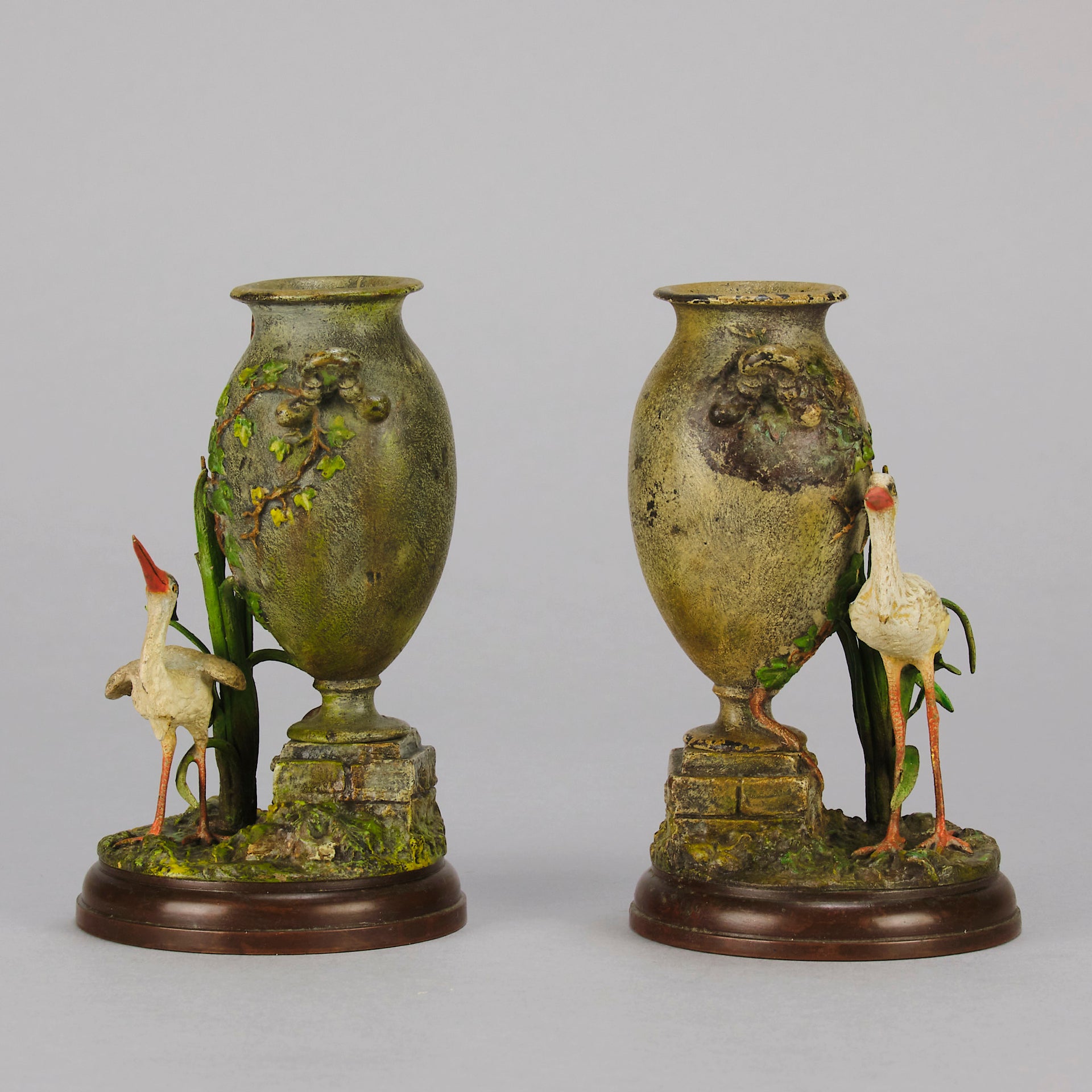 A Pair of Bird Vases by Franz Bergman decorated with Ibis standing amongst bulrush raised on a naturalistic bases with very fine colours and good hand finished surface detail 