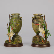 A Pair of Bird Vases by Franz Bergman decorated with Ibis standing amongst bulrush raised on a naturalistic bases with very fine colours and good hand finished surface detail 