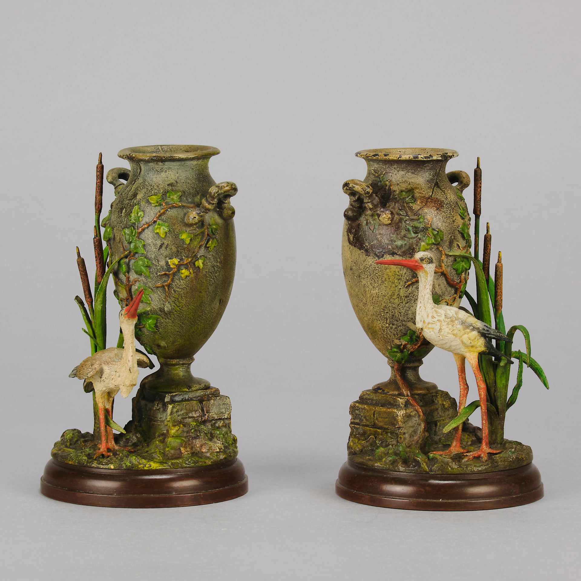 A Pair of Bird Vases by Franz Bergman decorated with Ibis standing amongst bulrush raised on a naturalistic bases with very fine colours and good hand finished surface detail 