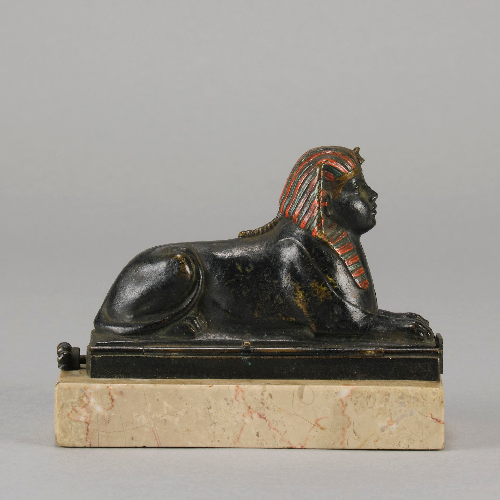 Erotic Sphinx by Franz Bergman a charming and erotic late 19th Century Austrian cold painted bronze figure of a recumbent sphinx, hinged and opening to reveal a naked beauty seated on a rug with gilt and enamel colour