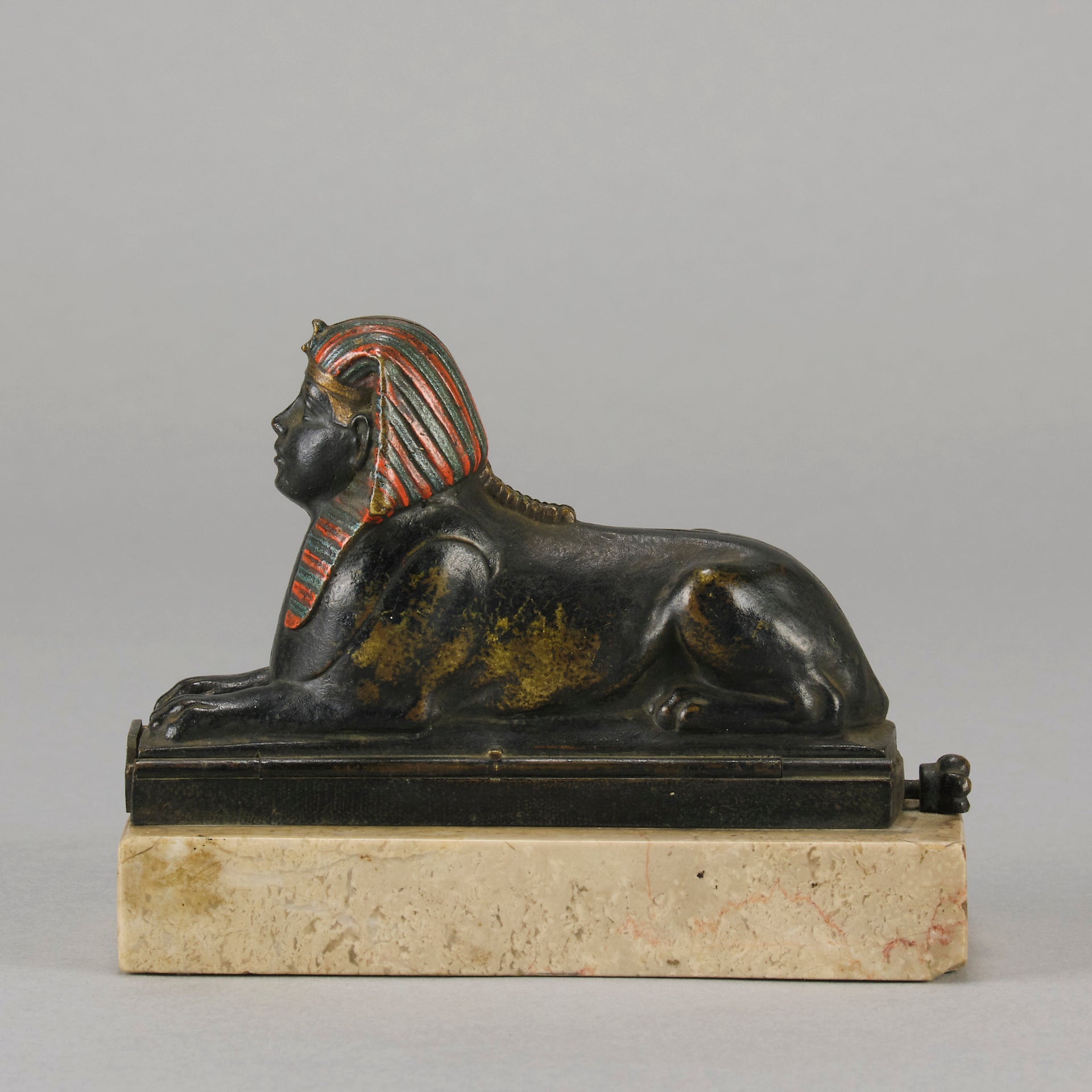 Erotic Sphinx by Franz Bergman a charming and erotic late 19th Century Austrian cold painted bronze figure of a recumbent sphinx, hinged and opening to reveal a naked beauty seated on a rug with gilt and enamel colour