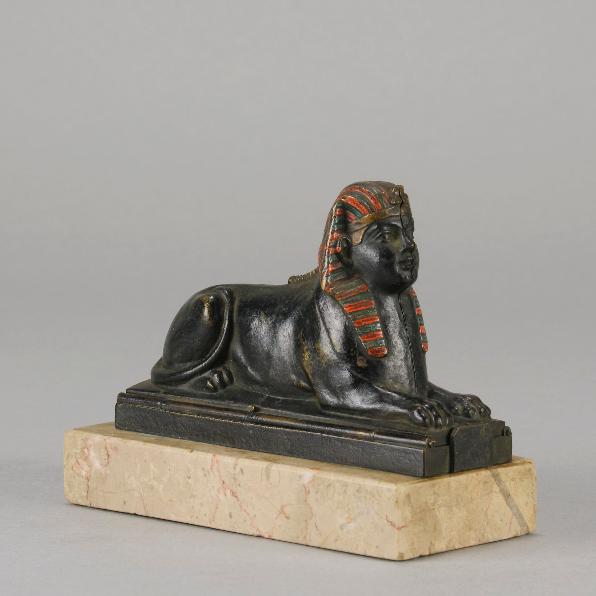Erotic Sphinx by Franz Bergman a charming and erotic late 19th Century Austrian cold painted bronze figure of a recumbent sphinx, hinged and opening to reveal a naked beauty seated on a rug with gilt and enamel colour