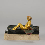 Erotic Sphinx by Franz Bergman a charming and erotic late 19th Century Austrian cold painted bronze figure of a recumbent sphinx, hinged and opening to reveal a naked beauty seated on a rug with gilt and enamel colour