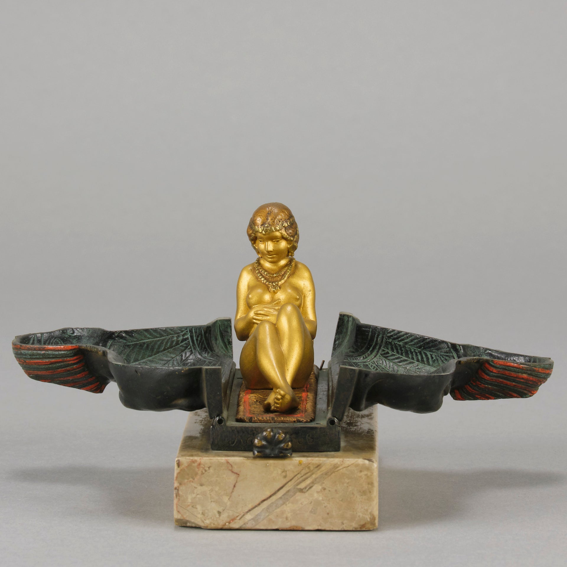 Erotic Sphinx by Franz Bergman a charming and erotic late 19th Century Austrian cold painted bronze figure of a recumbent sphinx, hinged and opening to reveal a naked beauty seated on a rug with gilt and enamel colour