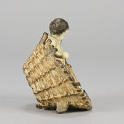 Girl & Cat with Basket - Bergman Bronze - A charming early 20th Century Austrian bronze group study of a young child and cat standing in a wicker basket playing with a ball of string - Hickmet Fine Arts