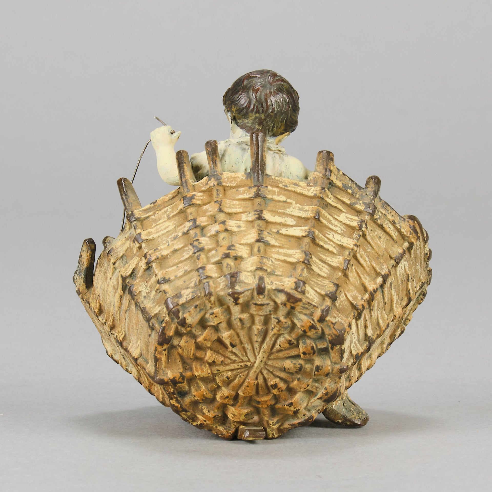 Girl & Cat with Basket - Bergman Bronze - A charming early 20th Century Austrian bronze group study of a young child and cat standing in a wicker basket playing with a ball of string - Hickmet Fine Arts