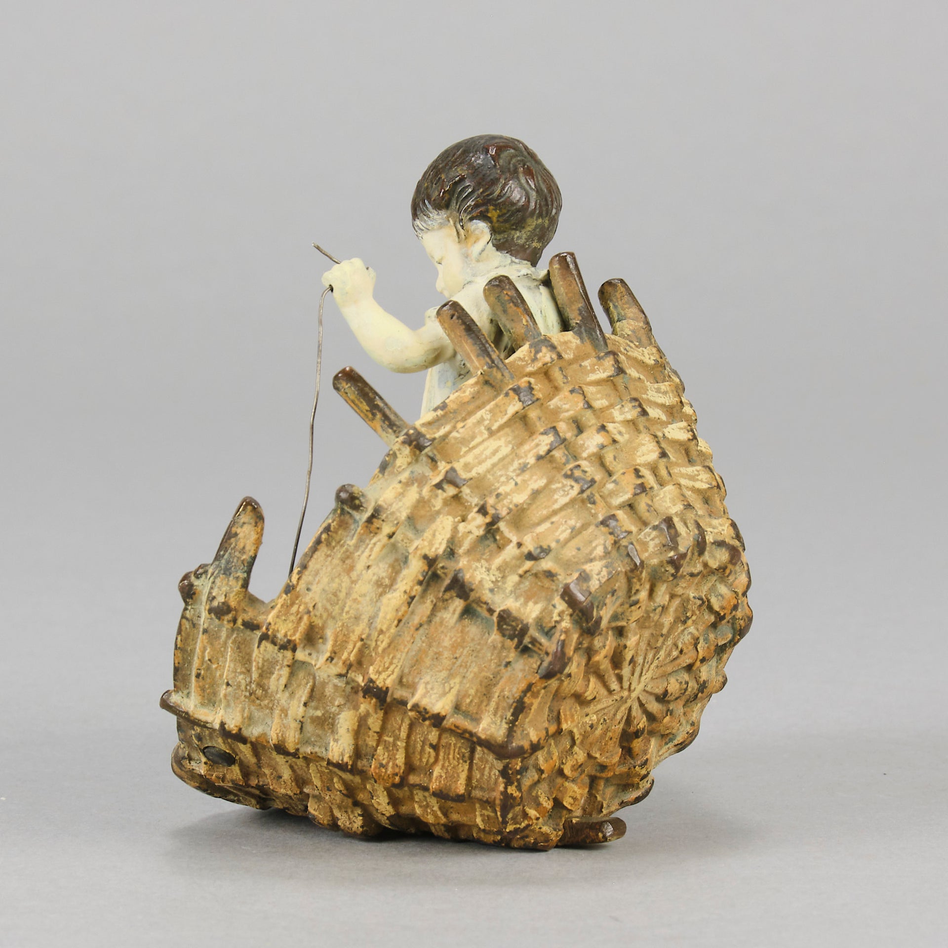 Girl & Cat with Basket - Bergman Bronze - A charming early 20th Century Austrian bronze group study of a young child and cat standing in a wicker basket playing with a ball of string - Hickmet Fine Arts