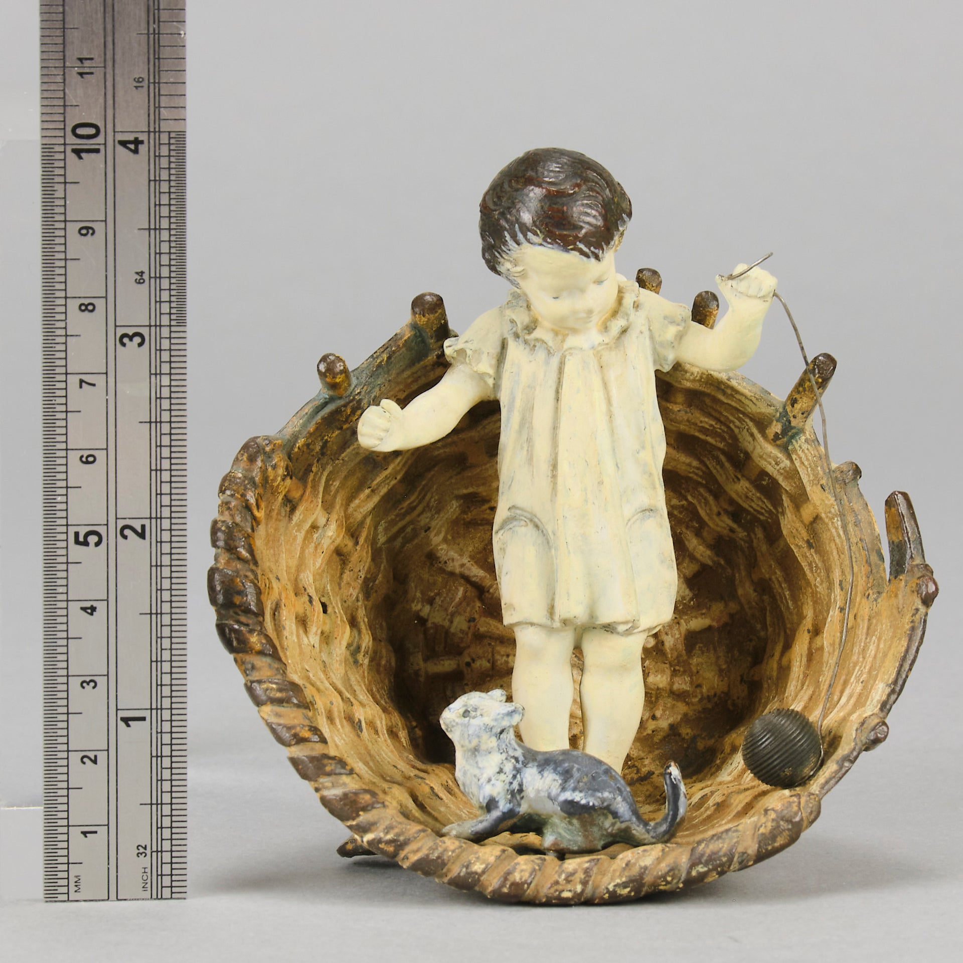Girl & Cat with Basket - Bergman Bronze - A charming early 20th Century Austrian bronze group study of a young child and cat standing in a wicker basket playing with a ball of string - Hickmet Fine Arts