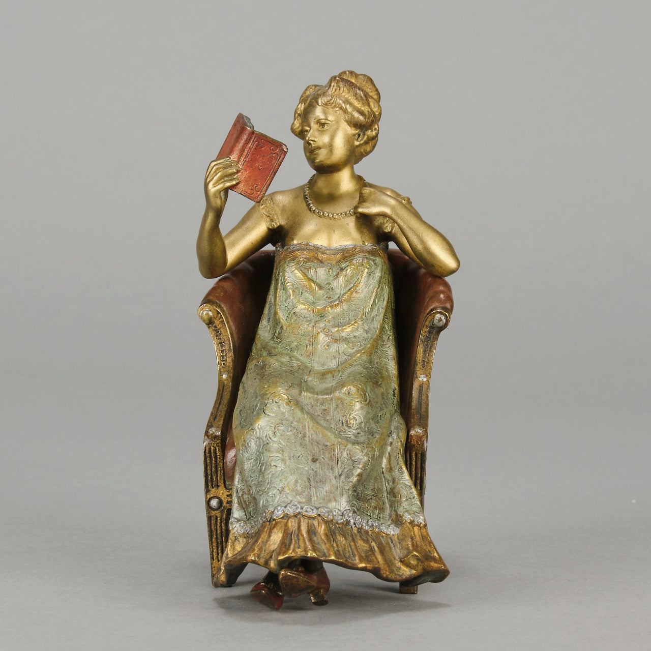 Lady Reading by Franz Bergman an attractive early 20th Century Austrian bronze study of a seated lady wearing a loosley fitted night dress reading a book, her dress lifting to reveal her beautiful body
