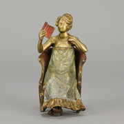 Lady Reading by Franz Bergman an attractive early 20th Century Austrian bronze study of a seated lady wearing a loosley fitted night dress reading a book, her dress lifting to reveal her beautiful body