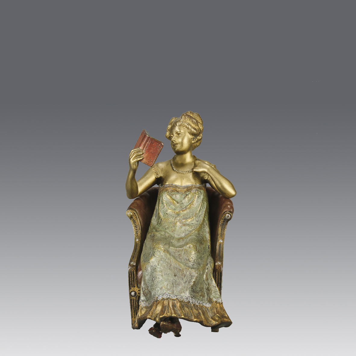 Lady Reading by Franz Bergman an attractive early 20th Century Austrian bronze study of a seated lady wearing a loosley fitted night dress reading a book, her dress lifting to reveal her beautiful body