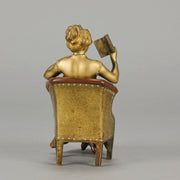 Lady Reading by Franz Bergman an attractive early 20th Century Austrian bronze study of a seated lady wearing a loosley fitted night dress reading a book, her dress lifting to reveal her beautiful body